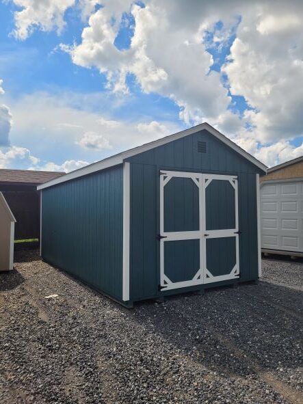 blue and white shed in lot