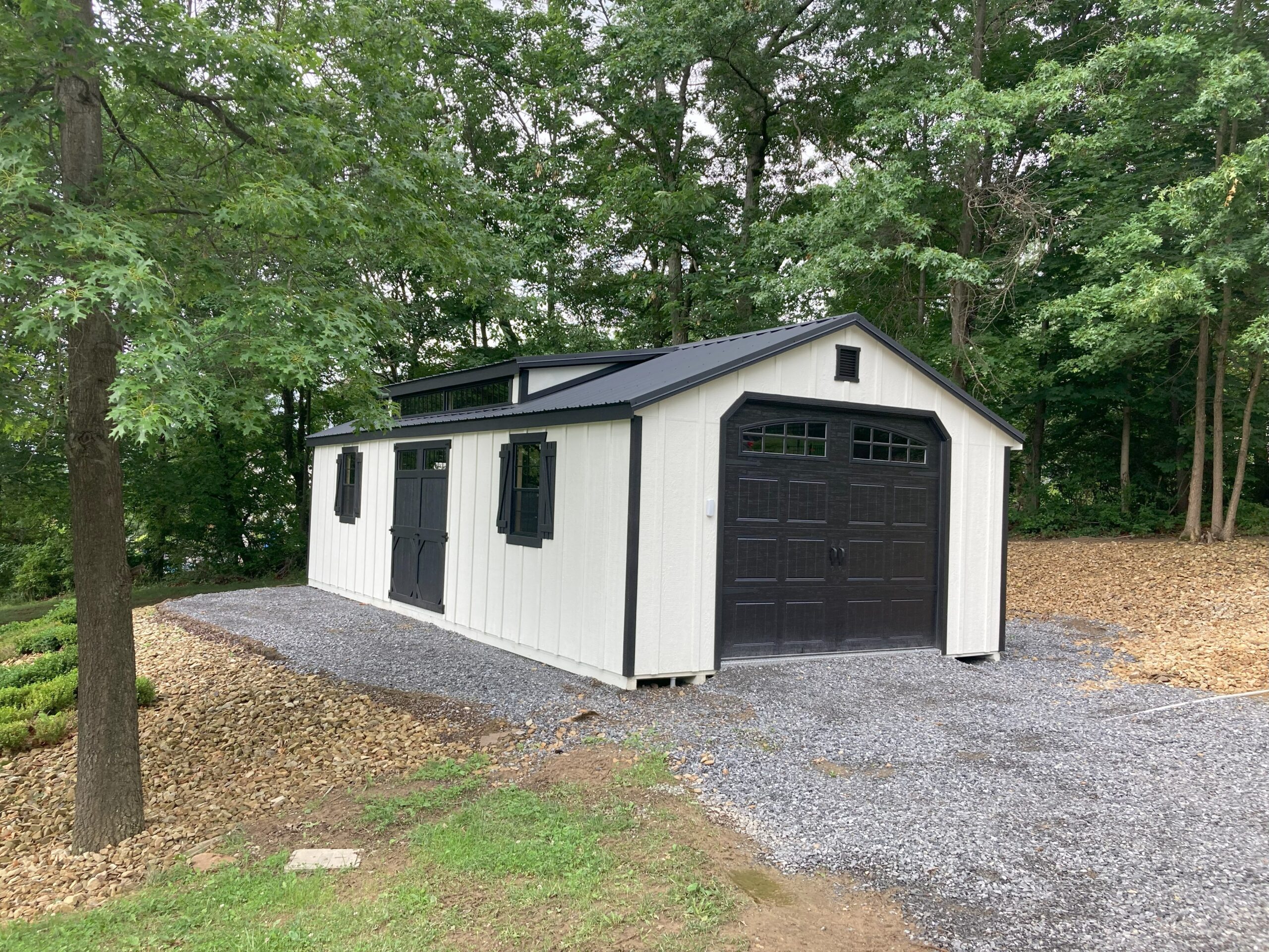 white garage with black roof and doors